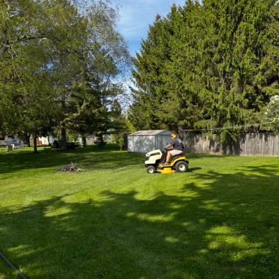 Riding lawn mower cutting grass.